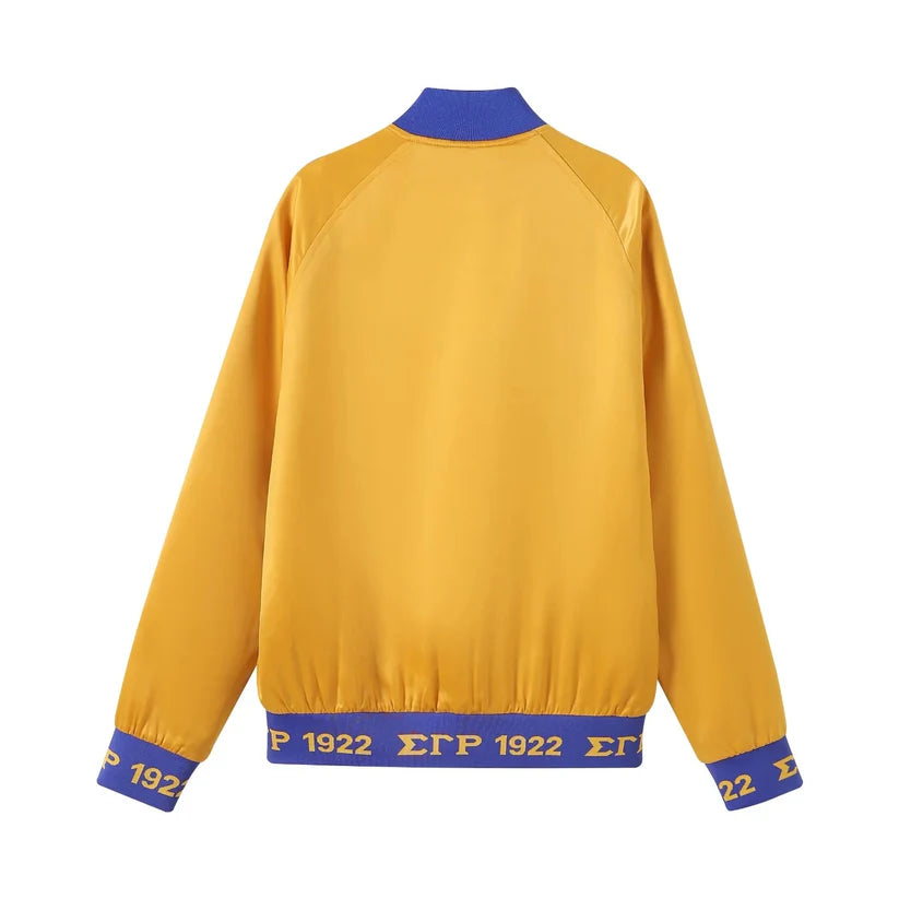 Sigma Gamma Rho Gold Satin Bomber Jacket for men or women. This unisex jacket features premium satin, royal blue ribbing, embroidered SGRho logos, and a quilted lining for a bold, luxurious style.