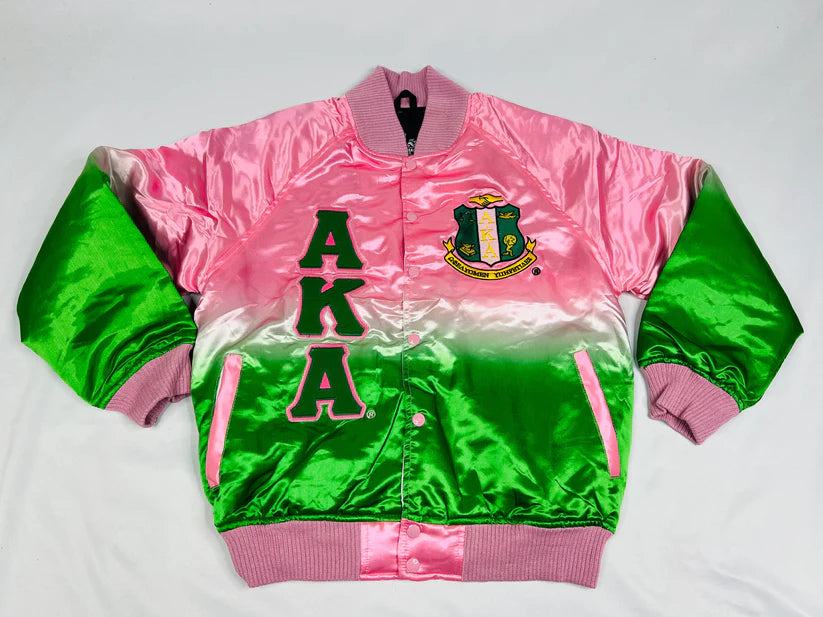 "Unisex Alpha Kappa Alpha (AKA) ombré satin bomber jacket featuring smooth satin fabric with a gradient color effect, pink ribbing and buttons, 100g quilted lining with custom interior, and embroidered AKA logos for a bold, stylish sorority look."