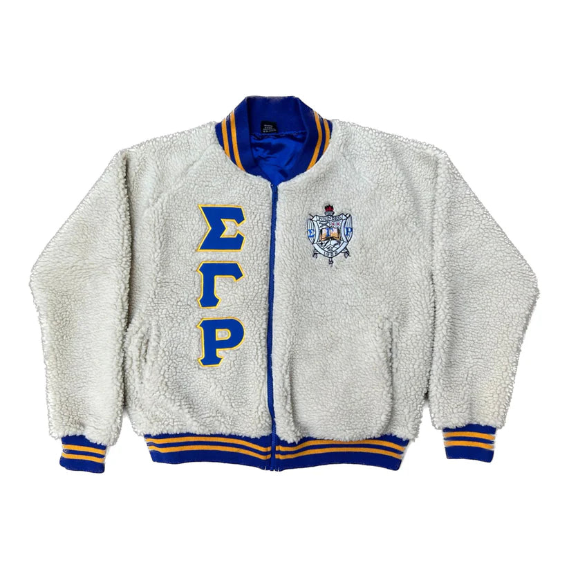Sigma Gamma Rho Sherpa Bomber Jacket for men or women. This unisex jacket features a soft, warm sherpa exterior and a classic, zip-up bomber style. Focus is on the premium texture and embroidered sorority details.