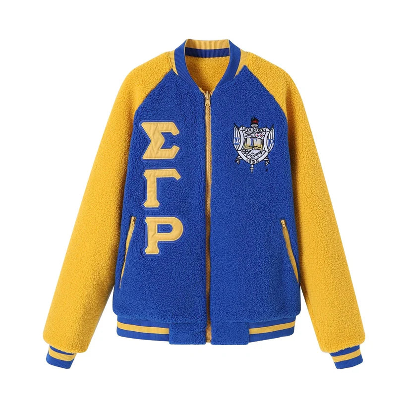 Sigma Gamma Rho Reversible Sherpa Bomber Jacket for men or women. This unisex two-in-one jacket features warm sherpa material and a sleek reverse side, along with embroidered SGRho logos for versatile style.