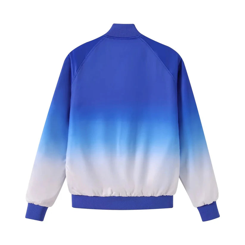 The Zeta Faded Bomber Jacket showcasing the smooth satin material and the unique Royal Blue fade to White color design. Highlights the embroidered Zeta logo, Royal Blue buttons, and ribbing.