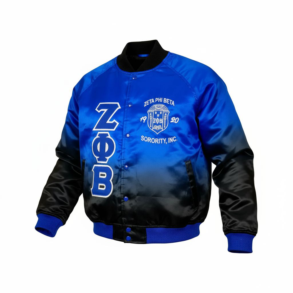 The Zeta Black Faded Bomber Jacket showcasing the smooth satin material and the unique Royal Blue fade to Black color design. Highlights the embroidered Zeta logo, Royal Blue buttons, and ribbed trim.