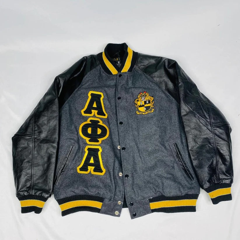 Luxurious Alpha Phi Alpha varsity letterman jacket featuring a dark grey 100% cashmere wool body, black 100% leather sleeves, and applique embroidered logos.