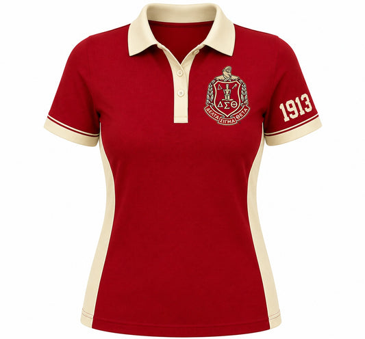 A women's short-sleeve polo shirt in deep red with cream-colored collar, sleeve cuffs, and side panels. The left chest features a gold and red Greek letter crest, and the right sleeve displays the number '1913' in cream and red.