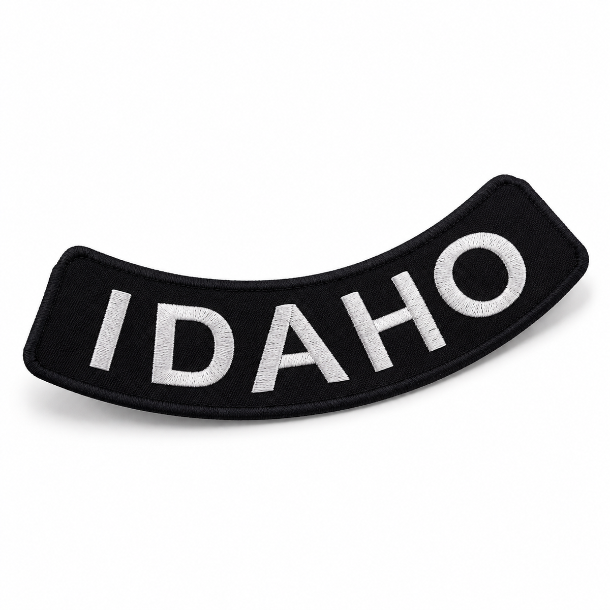 Idaho white on black embroidered bottom rocker patch — angled view showing curved shape