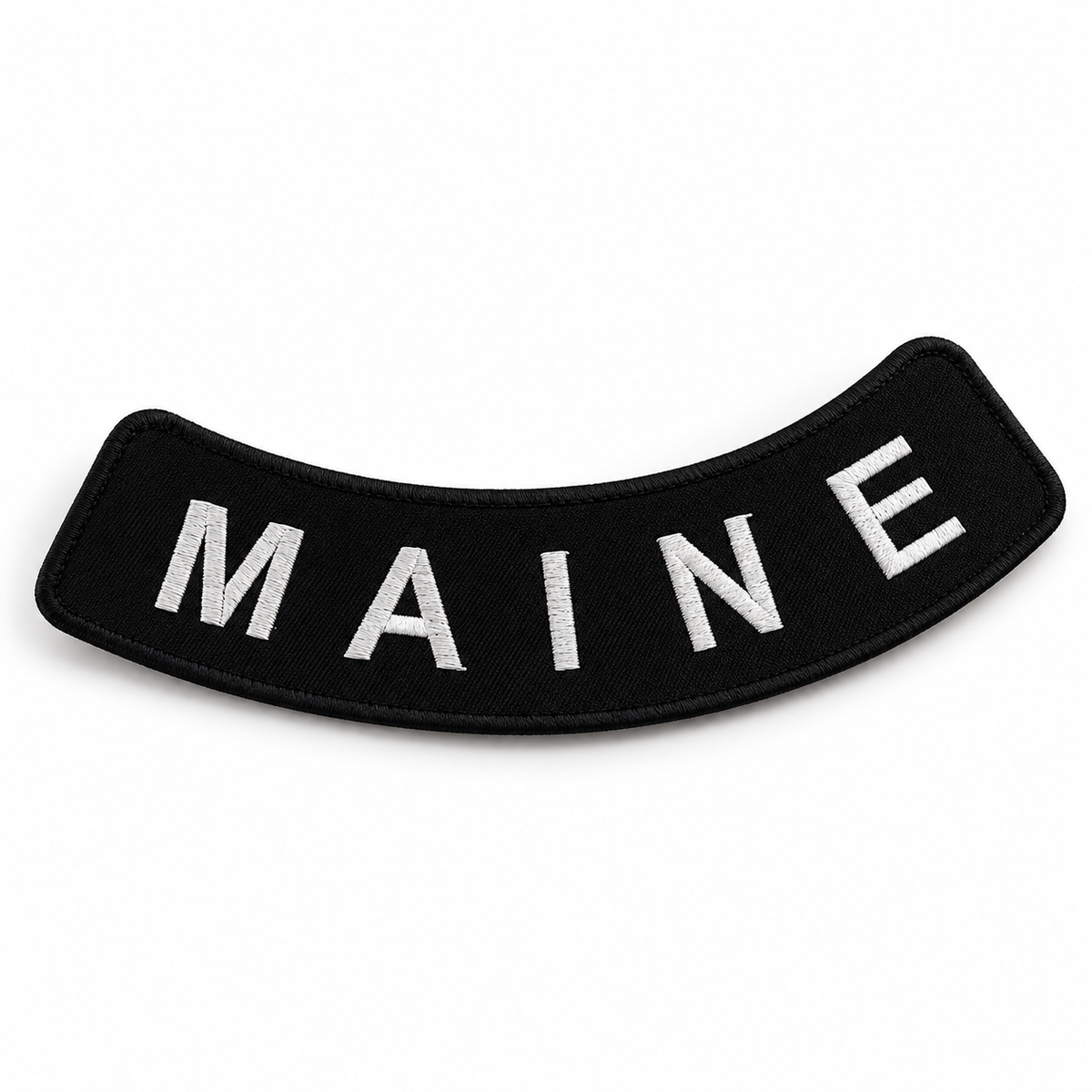 Maine white on black embroidered bottom rocker patch — angled view showing curved shape
