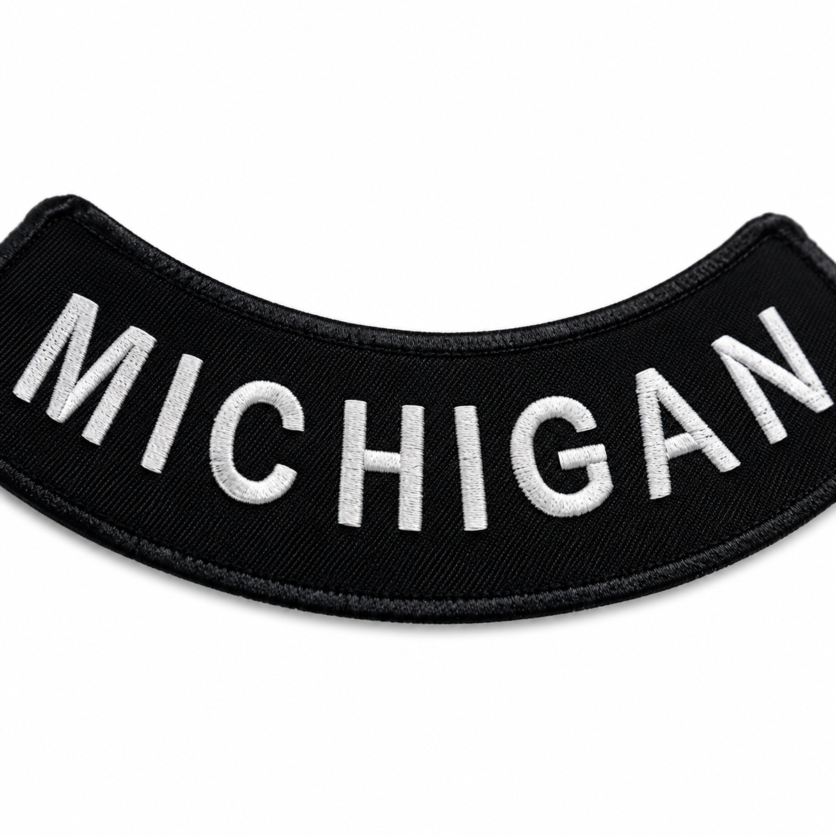 Michigan white on black embroidered bottom rocker patch — close-up of embroidery stitching