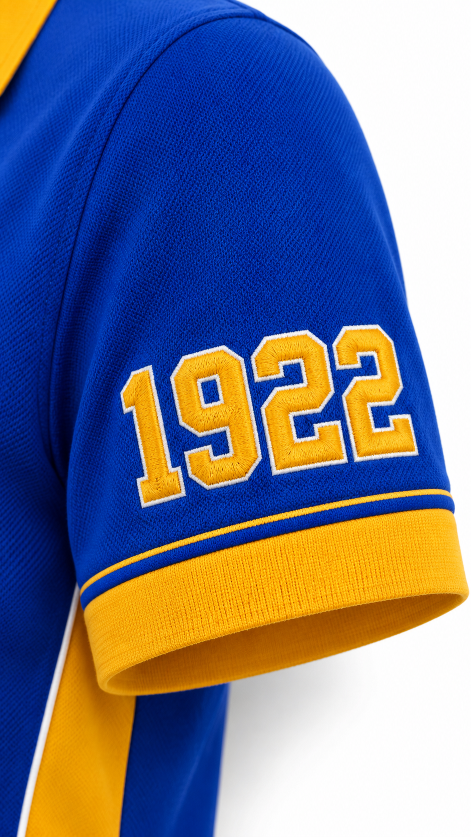 Close-up of gold 1922 sleeve embroidery on a royal blue Sigma Gamma Rho performance polo